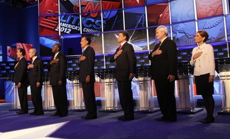 Republican presidential candidates listen to the national anthem before the start of the Republican Presidential Debate in Las Vegas