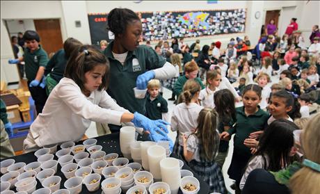 Fourth-grade student Boyd assists with a granola project at Forest Park Elementary School in Little Rock, Arkansas