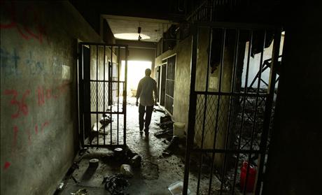 A CORRECTION OFFICER WALKS THROUGH THE CORRIDORS AT THE PRISON. 