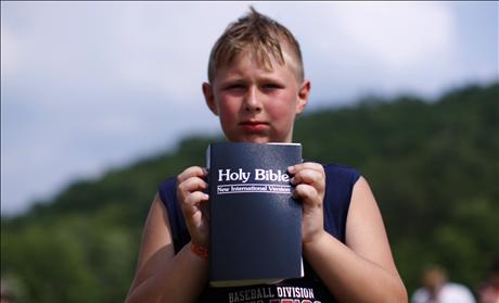 Boy with new bible after baptism during Creation08 Christian music festival in Mount Union Pennsylvania