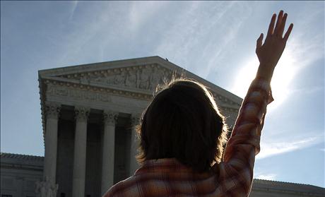 Anti-abortion advocate stands in prayer in front of Supreme Court in Washington DC