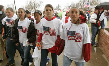 Students wearing t-shirts with U.S. flag arrive at school in Westminster