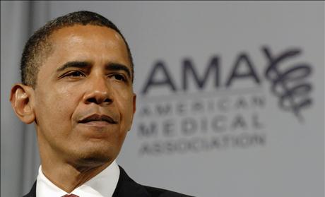 Obama pauses during a speech on health care to the American Medical Association in Chicago, Illinois