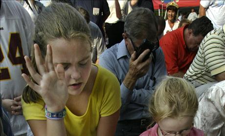 HILDREN PRAY OUTSIDE BUILDING HOLDING TEN COMMANDMENTS INSIDE THE ALABAMA JUDICIAL BUILDING IN MONTGOMERY.