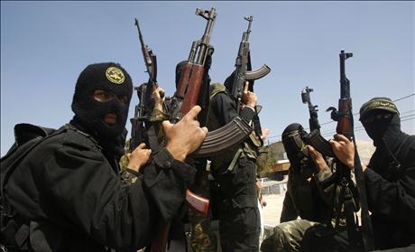 Palestinian militants from the Islamic Jihad group attend the funeral of their comrade Mohammed Moamar in Rafah, in the southern Gaza Strip