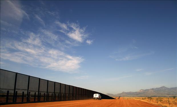 A U.S. Border vehicle drives along the U.S. and Mexico border fence in Naco, Arizona