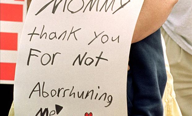 child with abortion sign