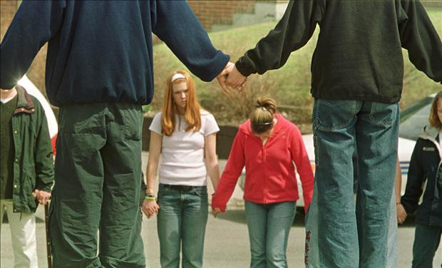 STUDENTS HOLD HANDS IN PRAYER AFTER STABBING AT HIGH SCHOOL.