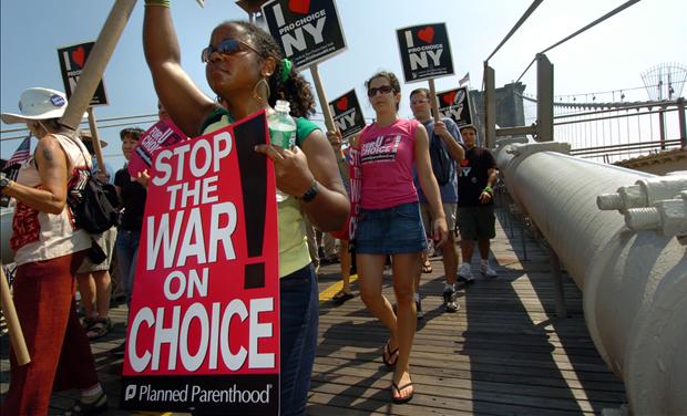 Reproductive rights protesters march on Brooklyn Bridge.