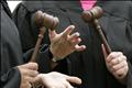 Women pro-choice protesters gather in judges' gowns and hold gavels outside the Supreme Court in Washington.