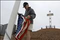 Clyde Rights raises flag next to Mount Soledad Cross which is being transferred to federal government ownership