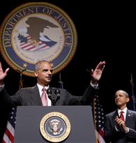 U.S. Attorney General Eric Holder of the Justice Department acknowledges the crowd and applause of U.S. President Barack Obama during a ceremonial installation at George Washington University in Washington
