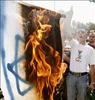 Jordanian supporters of opposition parties burn an Israeli flag and shout anti-Israel slogans during a demonstration in Amman
09/10/2009