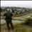 United States border patrol agent looks across the fence at Mexico as he patrols the U.S. border in San Ysidro, California,