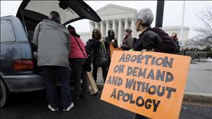 Abortion rights protestors arrive to prepare for a counter protest against March for Life anti-abortion demonstrators on the 39th anniversary of the Roe vs Wade decision, in front of the U.S. Supreme Court building in Washington 