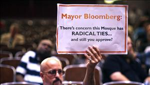 A demonstrator holds a sign during a Landmarks Commission's hearing on the proposed Cordoba Mosque to be built near the site of the former World Trade Center in New York
